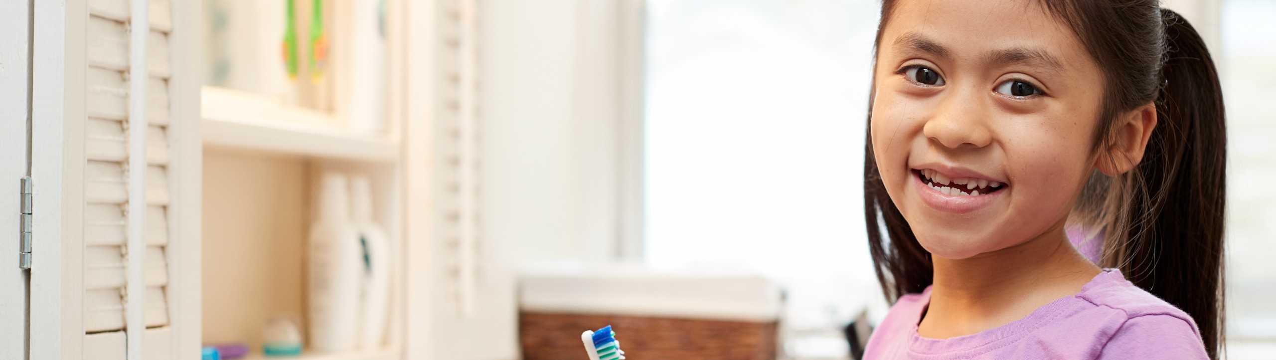 Girl brushing her teeth.