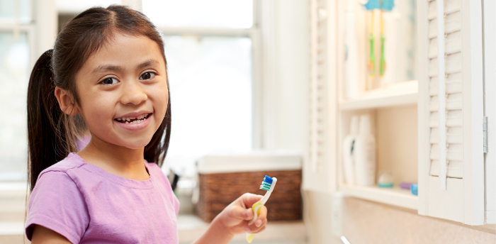 Girl brushing her teeth.