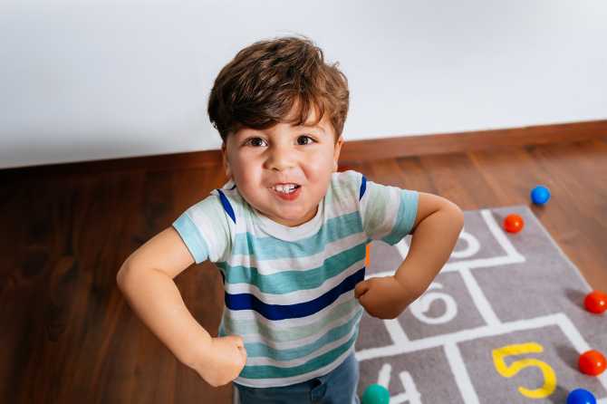 Young boy posing on a play-mat