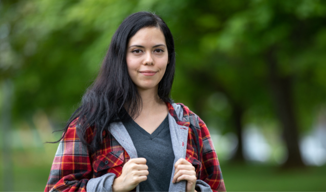 Person standing in front of trees