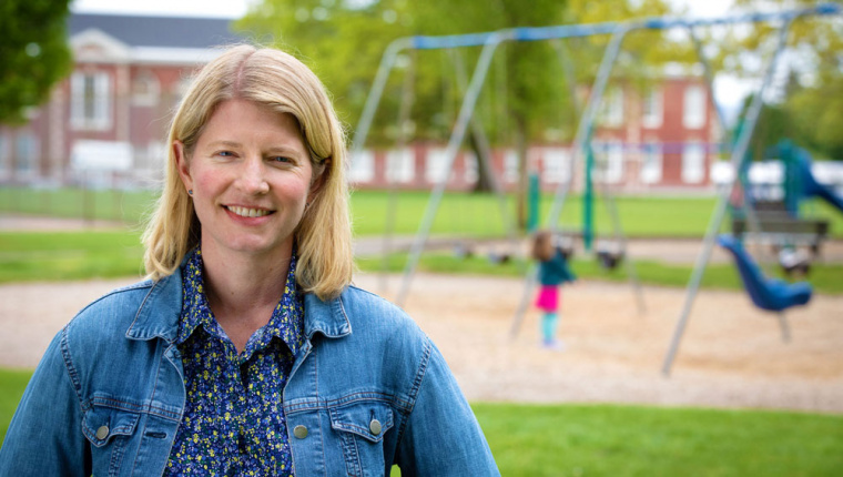 Person standing in front of swing set
