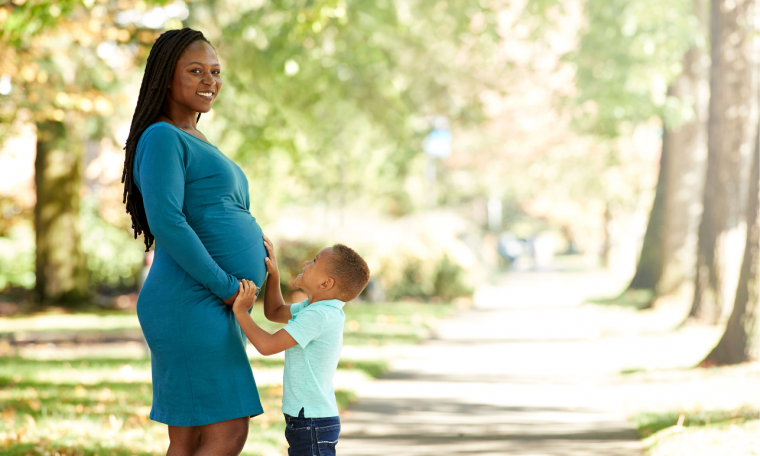 Pregnant person with young child