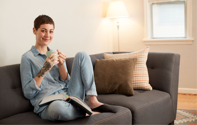Person sitting on couch with tea