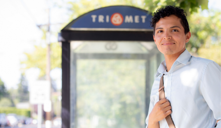 Person at bus stop looking into camera