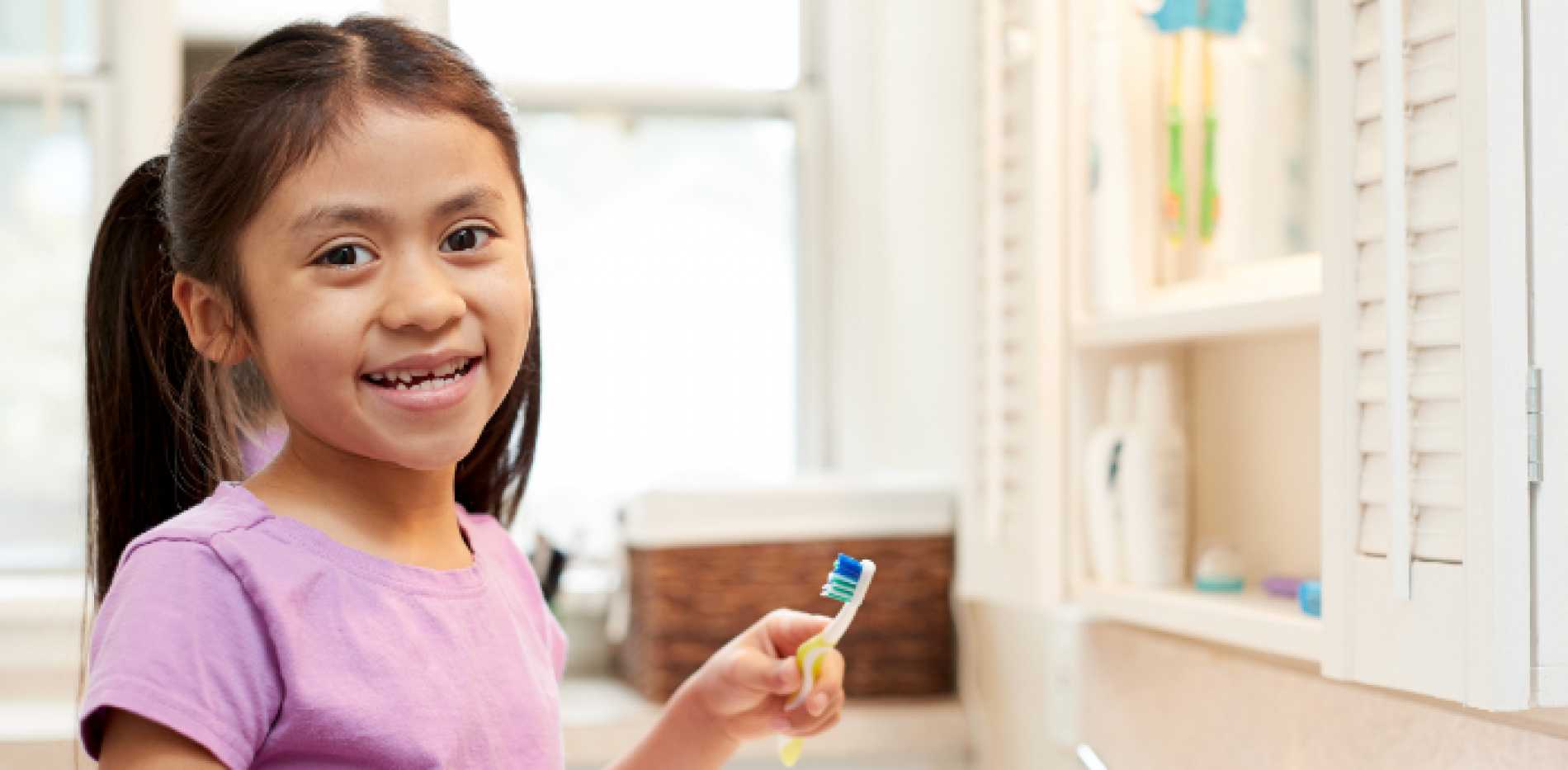 Girl brushing her teeth.