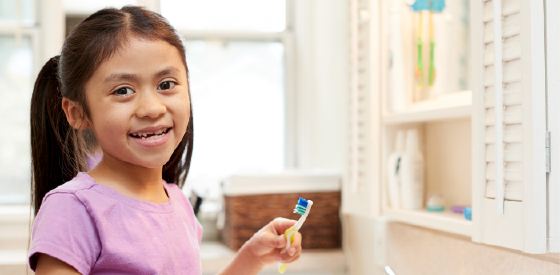 Girl brushing her teeth.